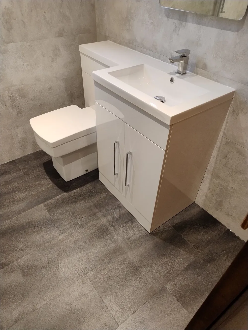 Combined vanity and WC unit fitted into a small bathroom